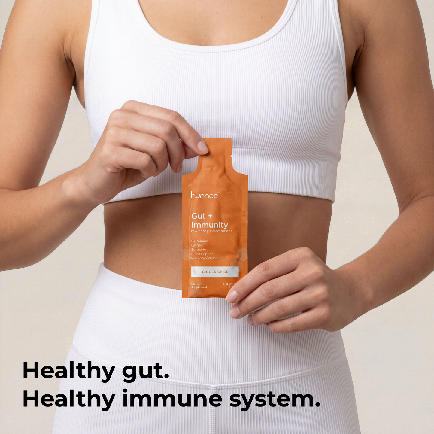 Person holding a supplement package with text about gut and immunity health.