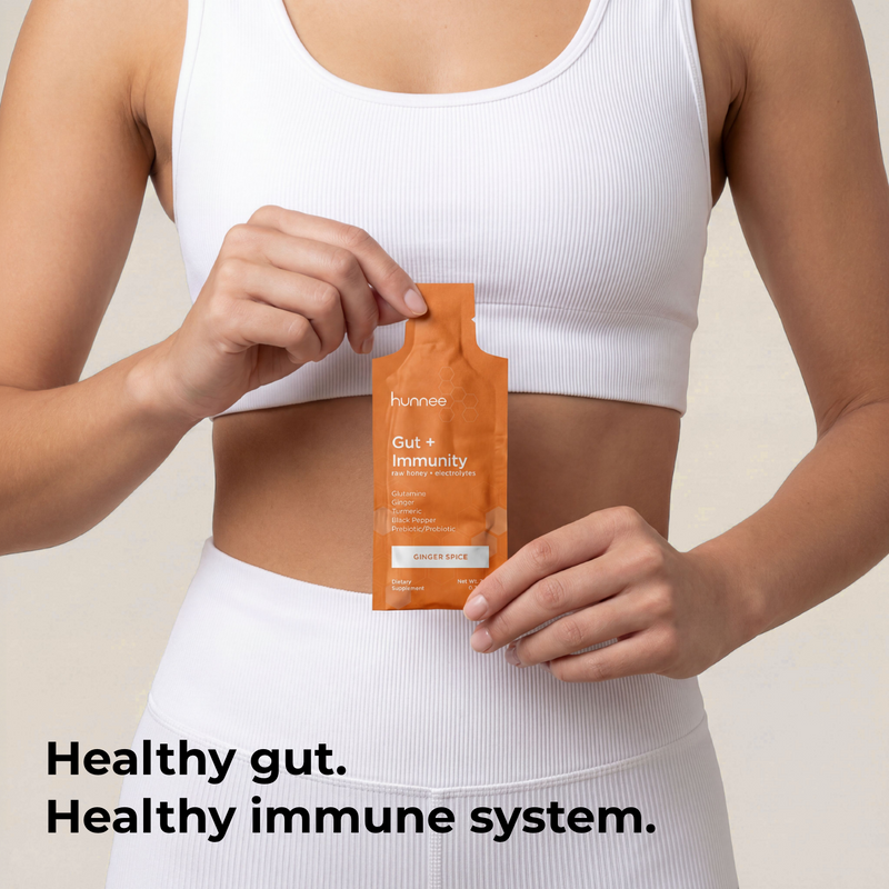 Person holding a supplement package with text about gut and immunity health.