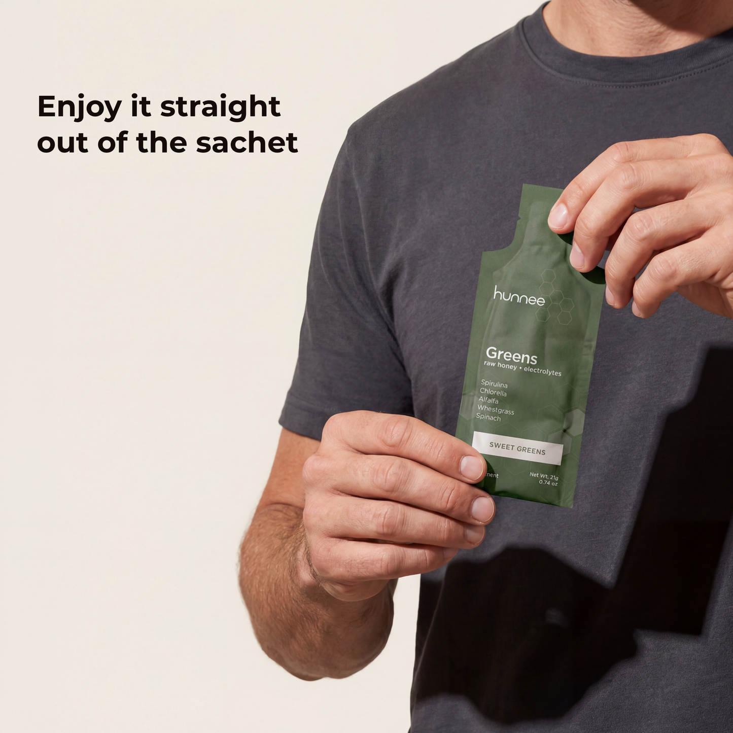 Person holding a green 'hunnee' product packaging against a neutral background