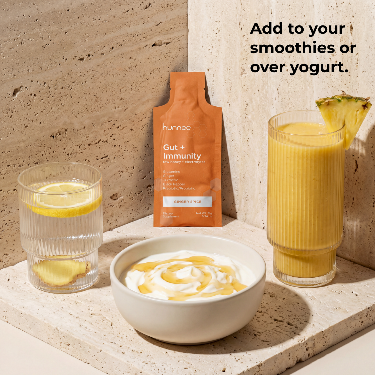 Hunnee Gut + Immunity supplement package with a smoothie, yogurt, and lemon on a stone surface.