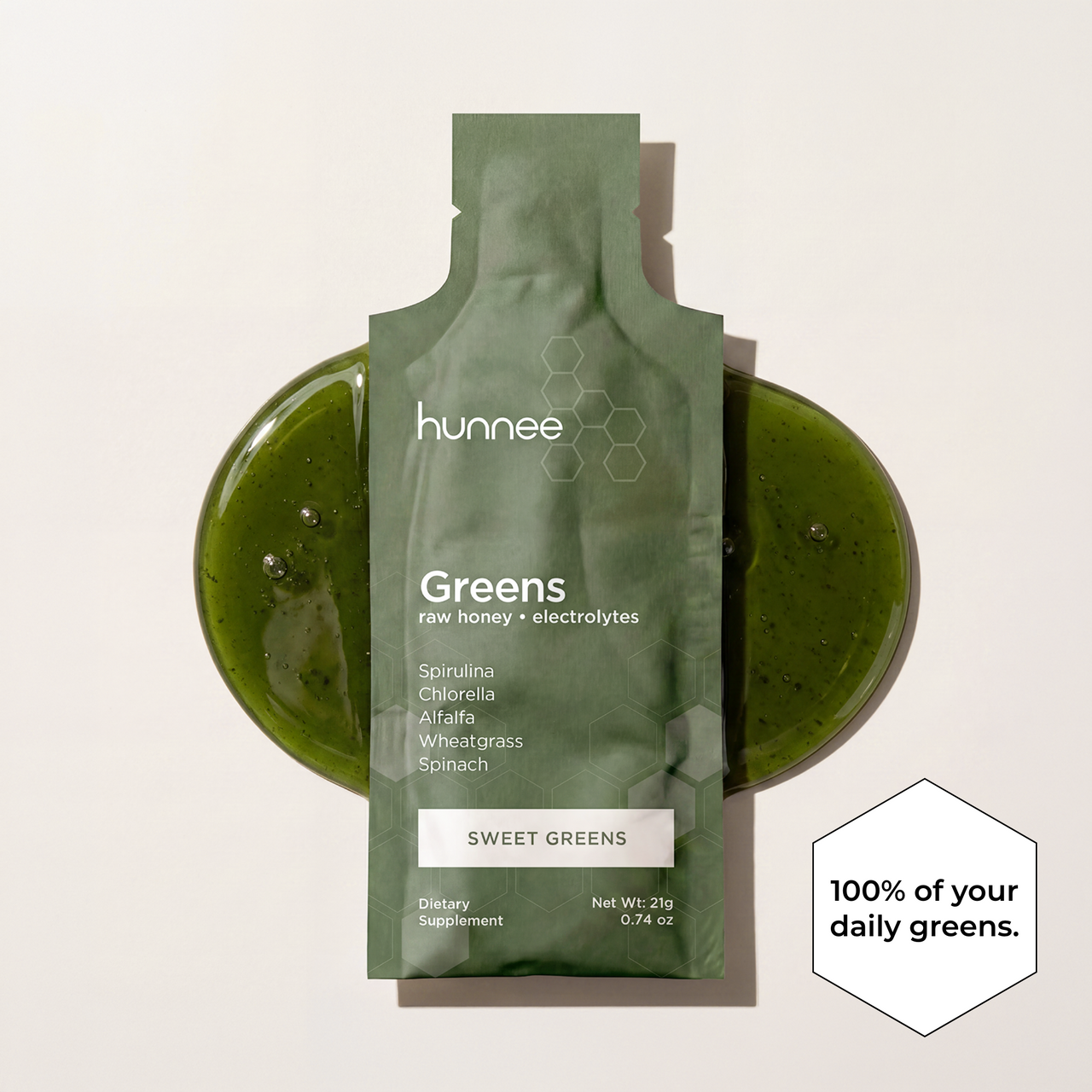 Green package of hunnee Greens supplement on a light gray background