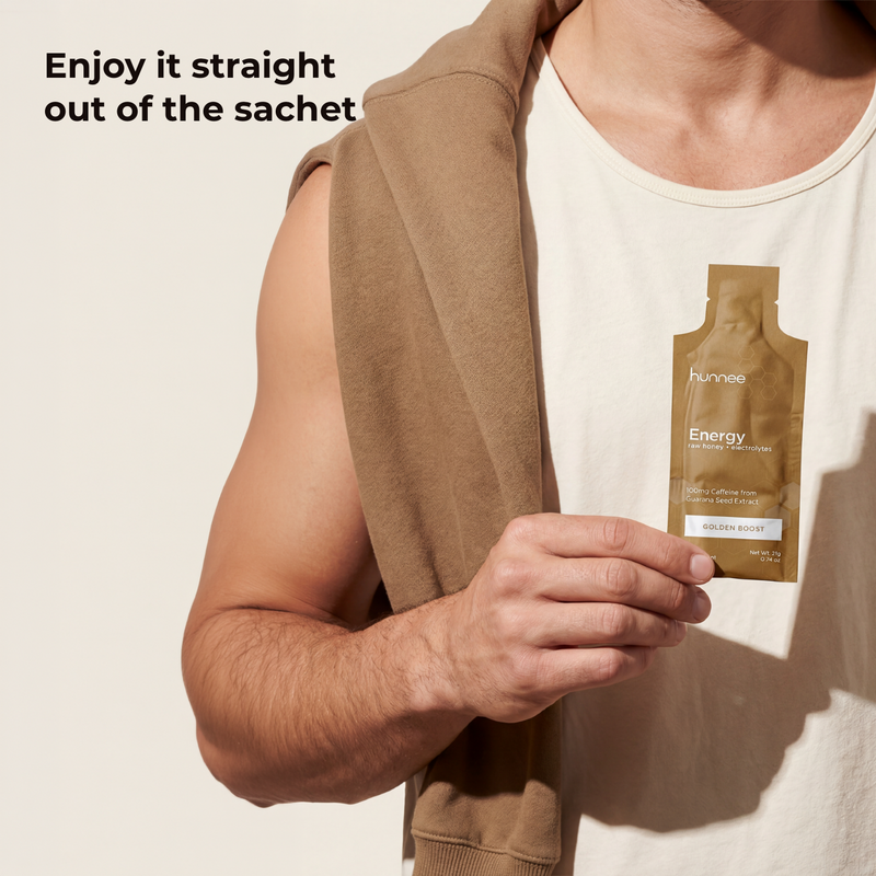 Person holding a brown sachet with 'hunnee' branding against a neutral background