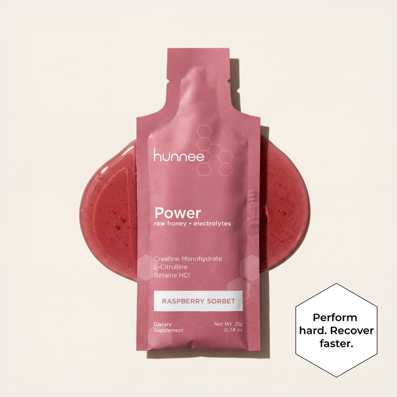 Pink hunnee Power supplement packet with raspberry sorbet flavor on a beige background